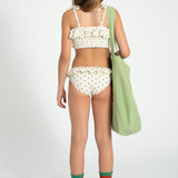 Girl ecru bikini with black hearts and ruffles