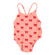 baby swimsuit w/ crossed straps |  pink w/ red bows